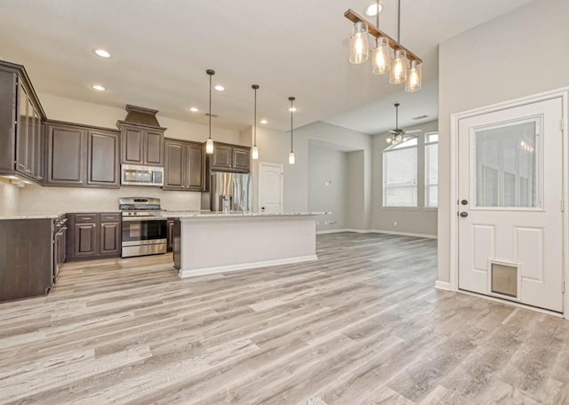 kitchen featuring stainless steel appliances, ceiling fan, and dark brown cabinets