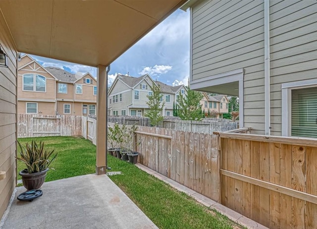 view of patio featuring a fenced backyard and a residential view