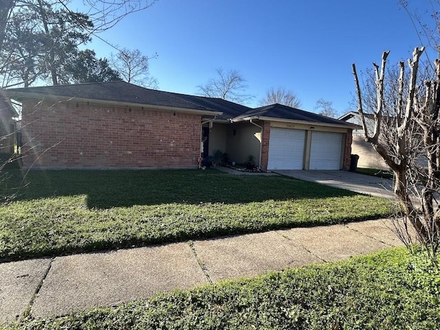 view of front of home with a front lawn, an attached garage, brick siding, and driveway