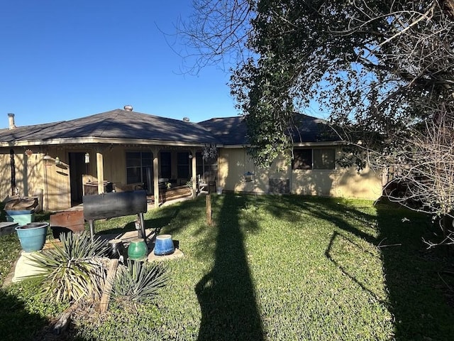 back of house with a yard