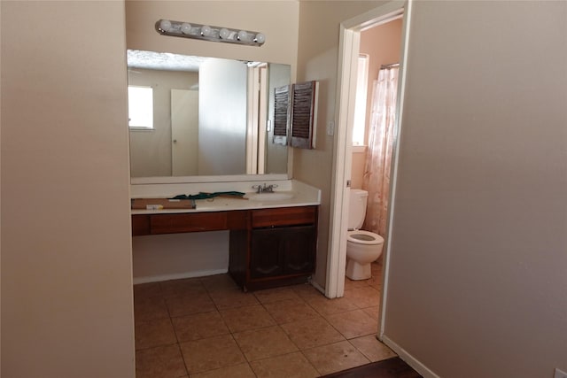 bathroom featuring tile patterned floors, vanity, and toilet