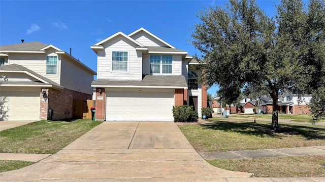 view of front facade with an attached garage, driveway, a front lawn, and brick siding