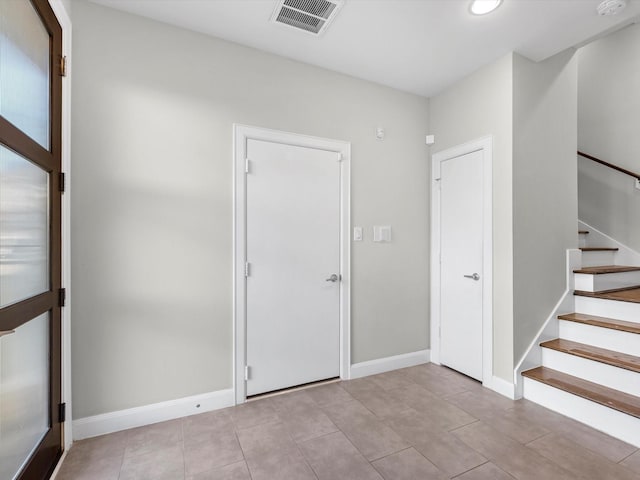 unfurnished room featuring light tile patterned floors, recessed lighting, visible vents, stairway, and baseboards