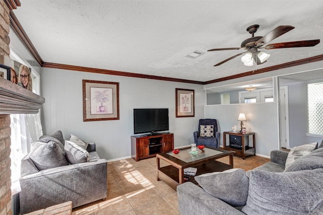 living room with visible vents, a ceiling fan, a textured ceiling, light tile patterned flooring, and crown molding