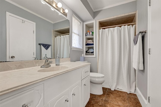 bathroom featuring tile patterned floors, vanity, toilet, and crown molding