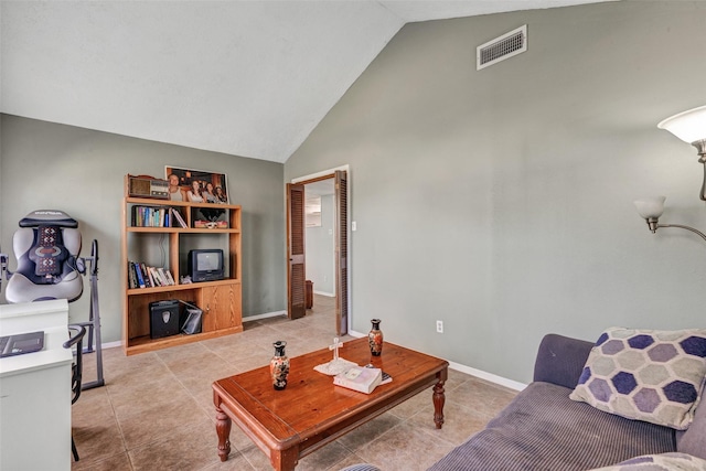 living area with light tile patterned floors, visible vents, baseboards, and high vaulted ceiling