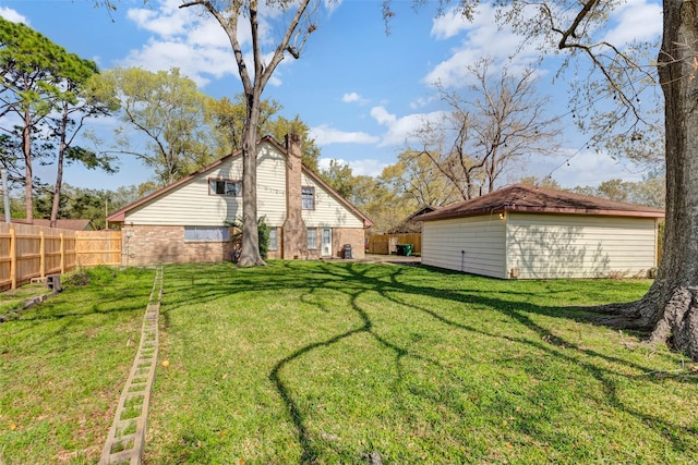 view of yard with an outbuilding and fence