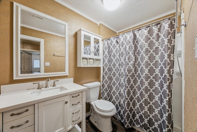 bathroom with a textured ceiling, a textured wall, toilet, vanity, and crown molding