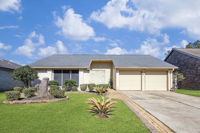 view of front facade with concrete driveway, brick siding, an attached garage, and a front lawn