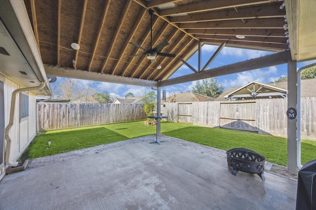 view of patio featuring ceiling fan, a gazebo, a fire pit, and a fenced backyard