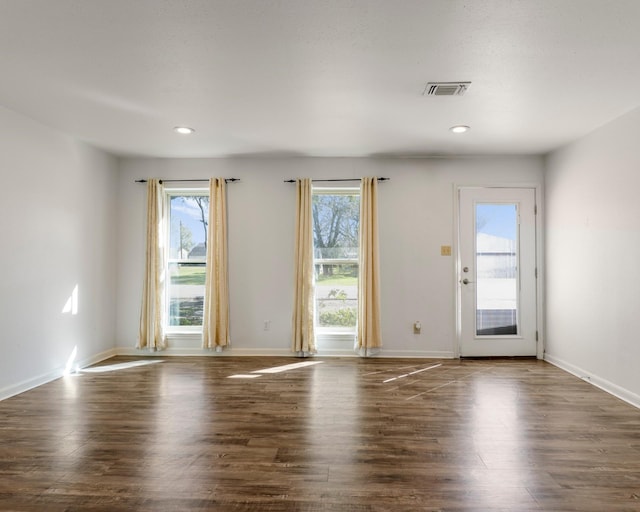 doorway to outside with recessed lighting, wood finished floors, visible vents, and baseboards