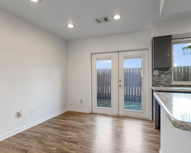 interior space featuring french doors, recessed lighting, visible vents, wood finished floors, and baseboards