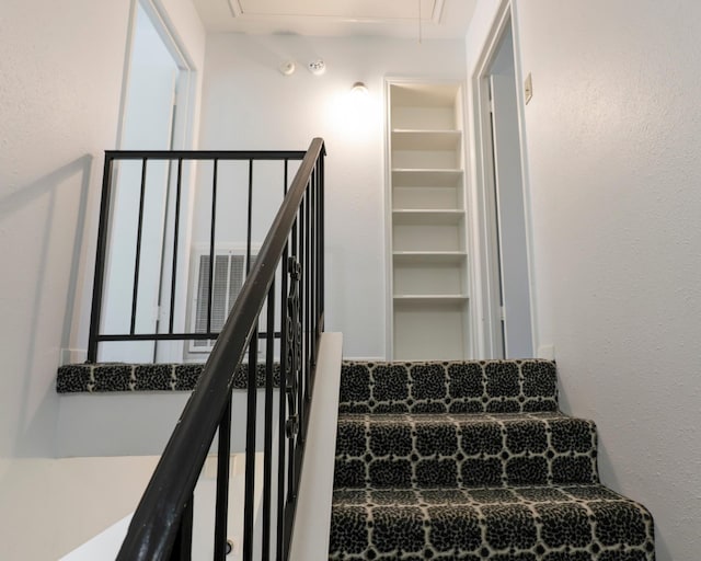 stairway featuring attic access