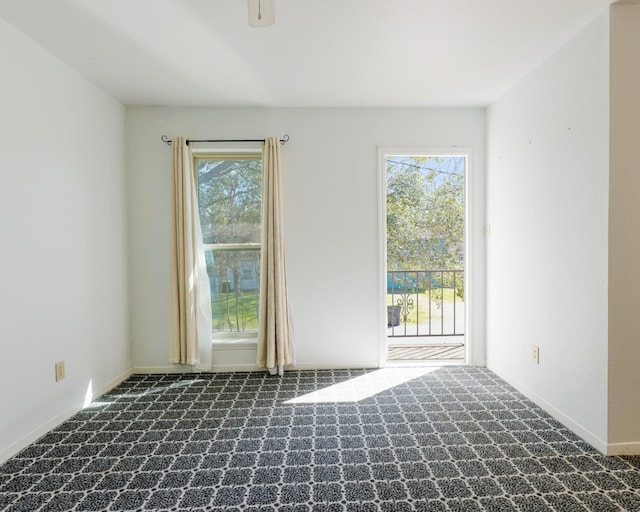 empty room with a healthy amount of sunlight, carpet, and baseboards