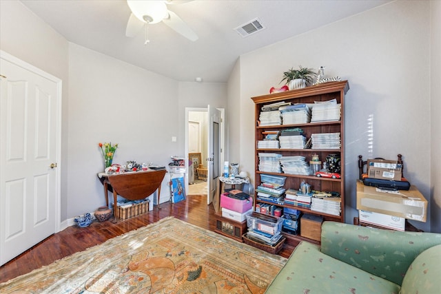 office area with visible vents, ceiling fan, baseboards, and wood finished floors