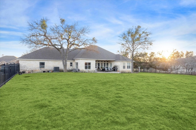 back of property featuring a yard, a patio, and fence