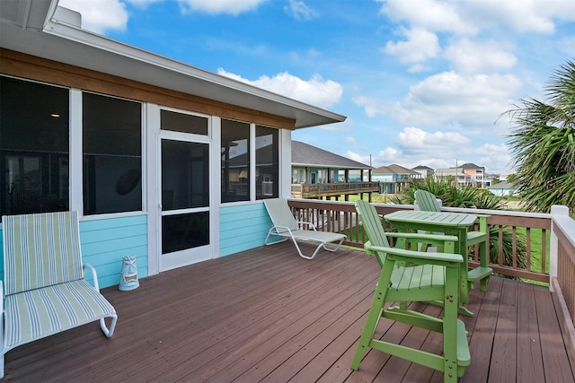 deck with a sunroom and a residential view