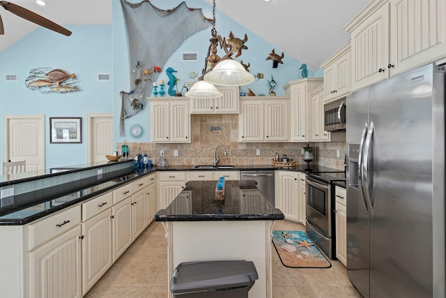 kitchen featuring light tile patterned floors, visible vents, a peninsula, stainless steel appliances, and cream cabinetry