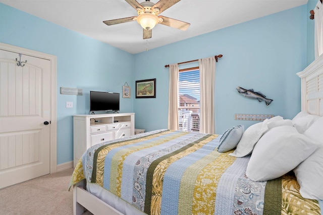 bedroom featuring a ceiling fan and light colored carpet