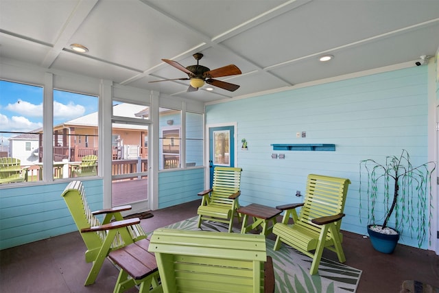 sunroom with coffered ceiling and a ceiling fan