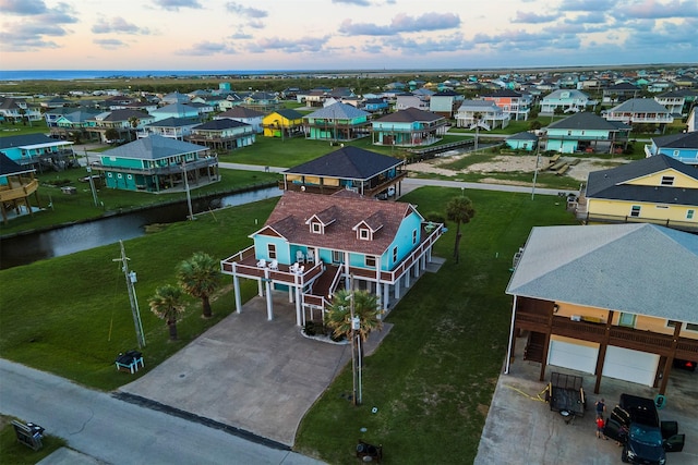 birds eye view of property featuring a water view and a residential view