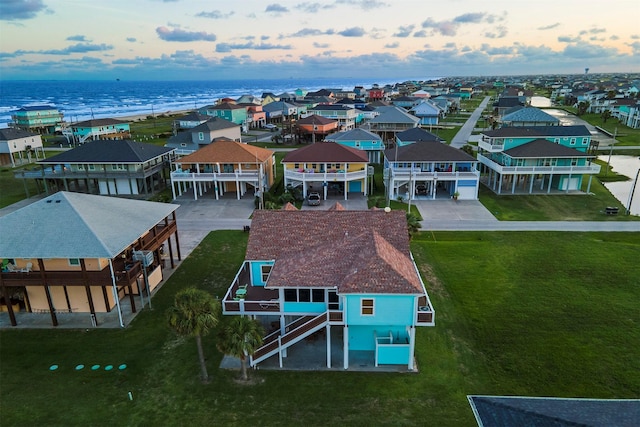 drone / aerial view featuring a water view and a residential view