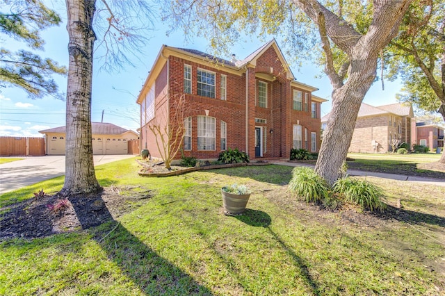 colonial house with a garage, an outbuilding, fence, a front lawn, and brick siding