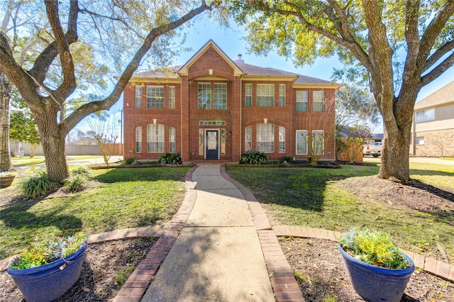 view of front facade featuring a front lawn and brick siding