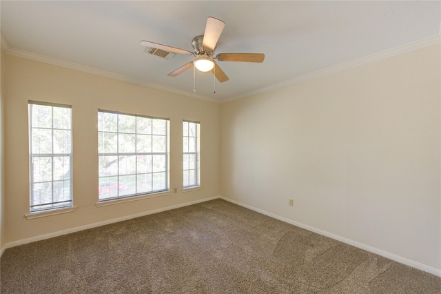 carpeted empty room featuring baseboards, ceiling fan, ornamental molding, and visible vents