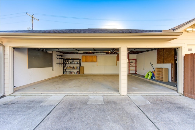garage featuring concrete driveway