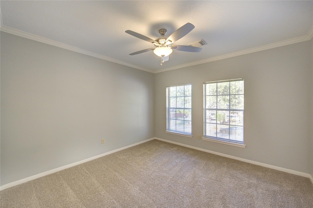 carpeted spare room featuring baseboards, crown molding, and ceiling fan