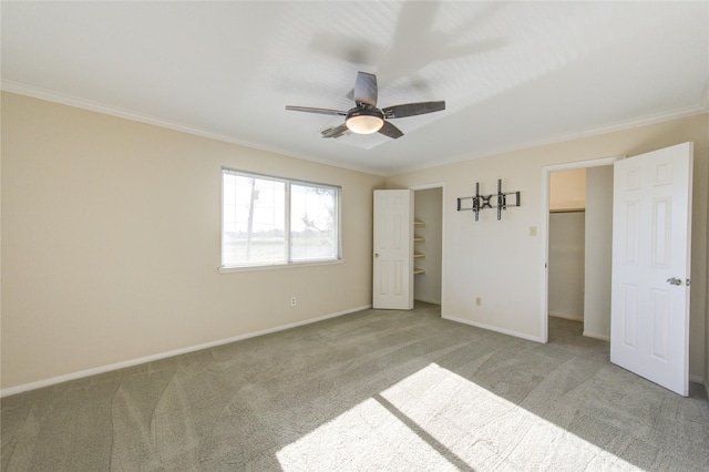 1016 Applewood Dr, Friendswood, TX 77546 - unfurnished bedroom with ornamental molding, carpet floors, a spacious closet, baseboards, and a ceiling fan