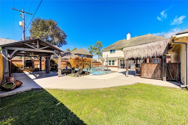 view of swimming pool featuring a lawn, a gazebo, a patio, and a fenced backyard