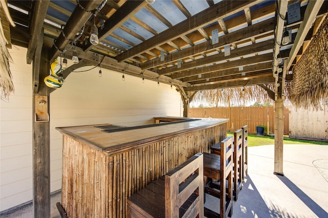 view of patio / terrace featuring fence and outdoor dry bar