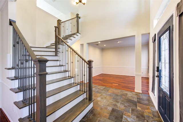 1016 Applewood Dr, Friendswood, TX 77546 - foyer entrance with baseboards, stairway, stone finish flooring, a high ceiling, and recessed lighting
