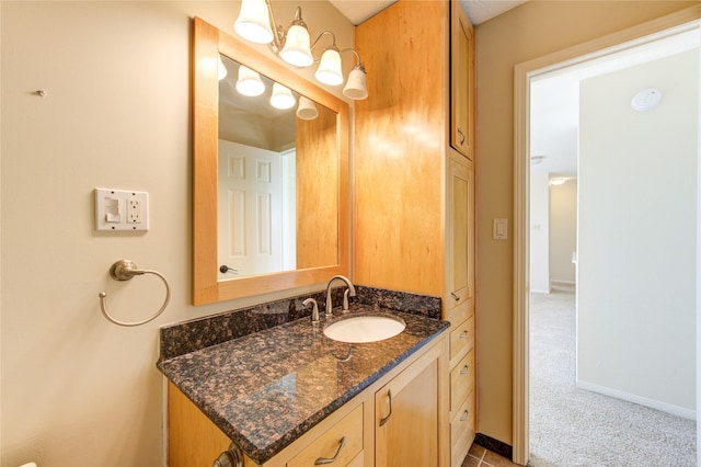 bathroom featuring baseboards and vanity