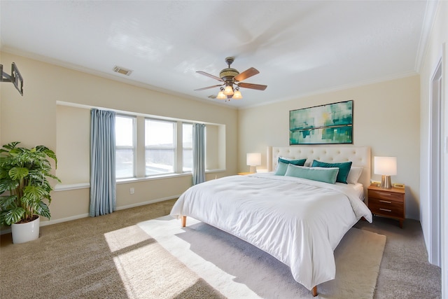 carpeted bedroom featuring baseboards, ceiling fan, ornamental molding, and visible vents