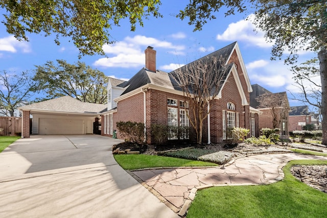 view of front of property featuring a garage, concrete driveway, brick siding, and a chimney