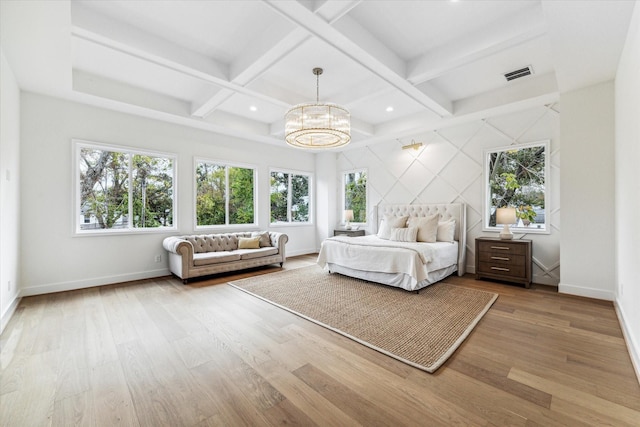 unfurnished bedroom featuring coffered ceiling, wood finished floors, visible vents, and a notable chandelier