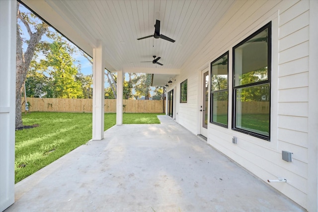 view of patio featuring ceiling fan and fence