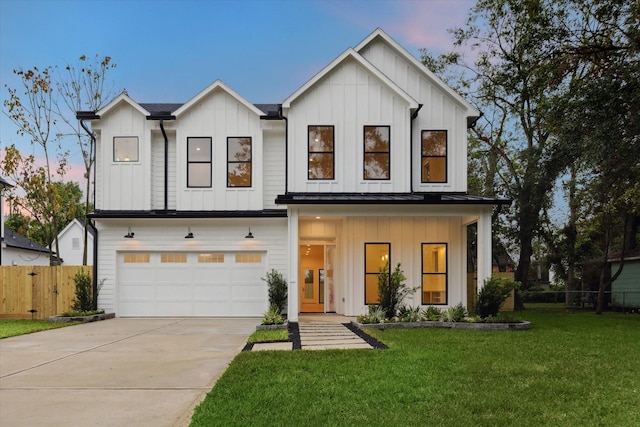 modern farmhouse style home featuring board and batten siding, concrete driveway, a yard, and fence