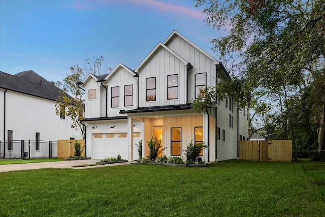 modern farmhouse style home with driveway, a garage, fence, and board and batten siding