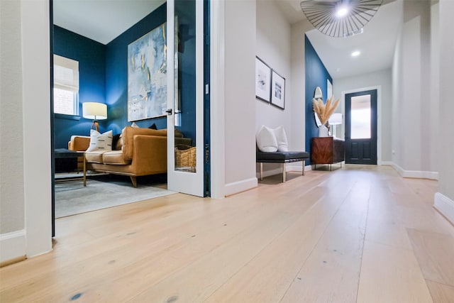 foyer featuring wood finished floors and baseboards