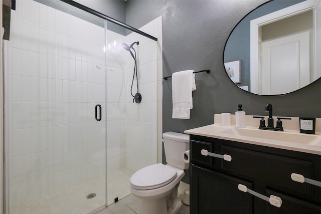 full bath with a stall shower, vanity, and toilet