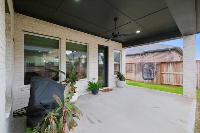 view of patio / terrace with fence and ceiling fan