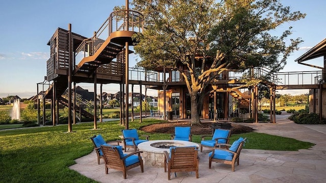 view of patio featuring a fire pit and stairway