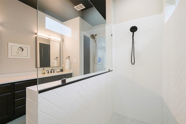 full bath featuring visible vents, walk in shower, and vanity