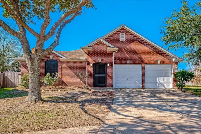 ranch-style house with driveway, an attached garage, fence, and brick siding