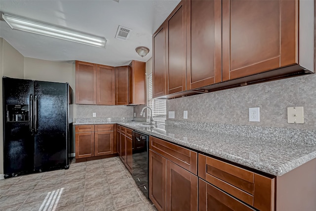 kitchen featuring tasteful backsplash, visible vents, a sink, and black appliances