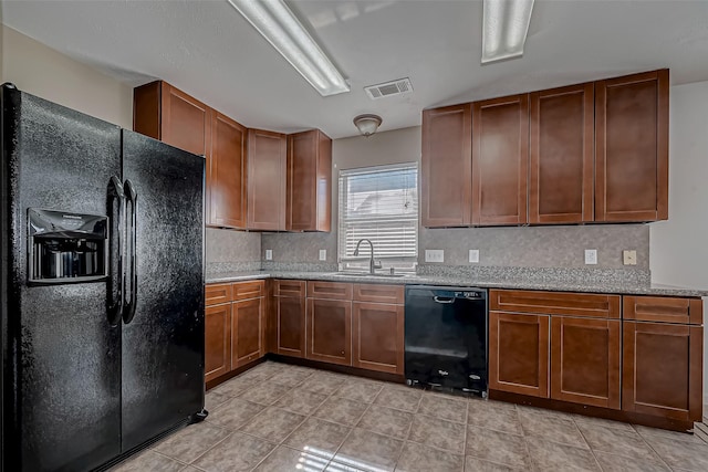 kitchen featuring visible vents, brown cabinets, a sink, black appliances, and backsplash